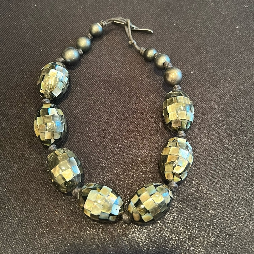 Unique faceted bead choker featuring a faux mother of pearl finish
